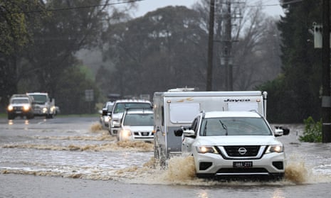 Cars cross a flooded road in Heathcote, Victoria, Australia