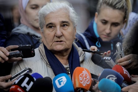 Munira Subašić speaks to press surrounded by mics