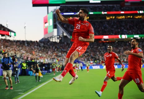 Nizar Al-Rashdan jumps for joy in front of the Jordan fans.