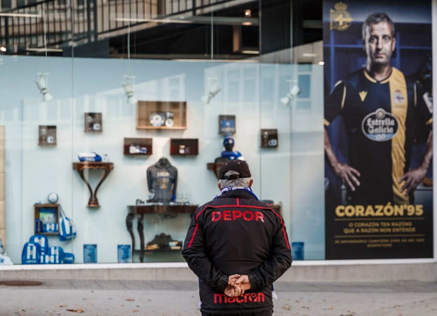 A Deportivo fan checks out the window of the club shop, including the commemorative shirt.