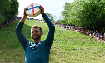 Matt Crolla, 28, won the first men’s downhill race – holding cheese aloft