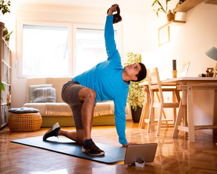 A man working out on a mat in a house