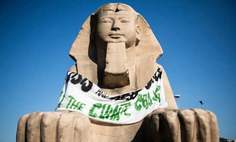 A protest banner placed by climate activists on the sphinx outside the Egyptian Museum of Turin in Italy in July.