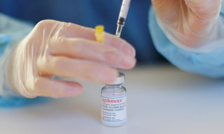 A nurse prepares a booster dose of the Moderna Covid-19 vaccine, Spikevax – a closeup of hands wearing surgical gloves drawing the vaccine from a small bottle into a syringe A nurse prepares a booster dose of the Moderna Covid-19 vaccine, Spikevax – a closeup of hands wearing surgical gloves drawing the vaccine from a small bottle into a syringe