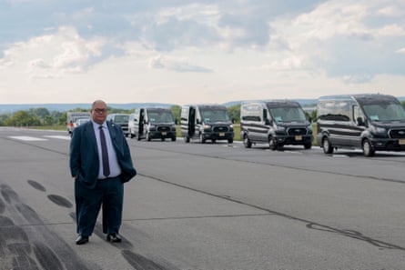 A man standing on the tarmac of an airport.