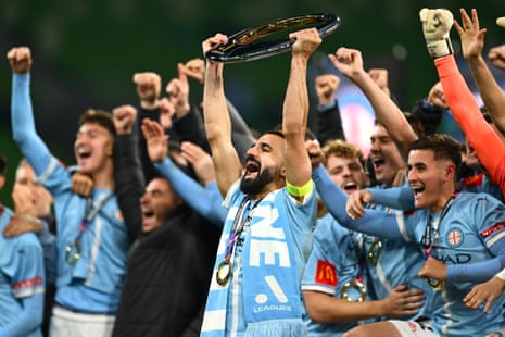 Aziz Behich of the City holds aloft the A-League Men Championship trophy after winning the A-League Men Grand Final