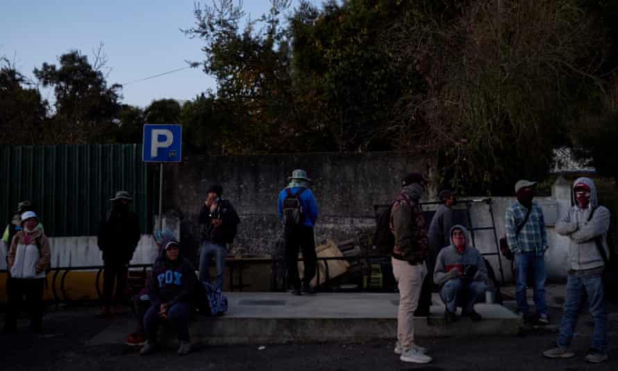 Berry pickers wait for their bus to work in the early morning.