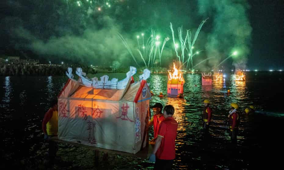 Pilgrims burn and release a water lantern into the sea during the Hungry Ghost Festival in Keelung, Taiwan. The lanterns are placed in the water and lit on fire guiding spirits to reincarnation.