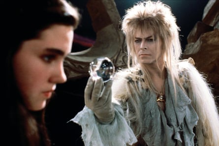 Jennifer Connelly and David Bowie, holding a crystal ball