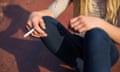 Closeup of teenage girl smoking cigarette