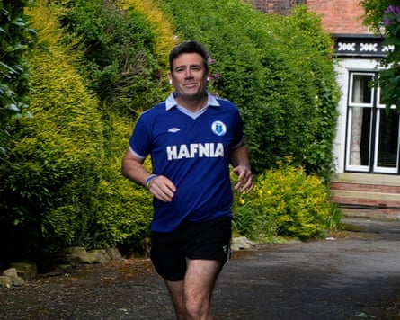 Andy Burnham wearing an Everton shirt while running outside his house in Warrington, Cheshire on 15 May 2026.