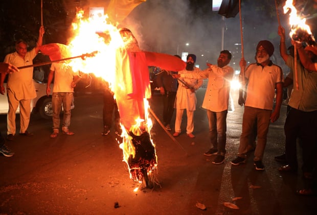Protestors burn an effigy of the Uttar Pradesh chief minister, Yogi Adityanath, in Kolkata.