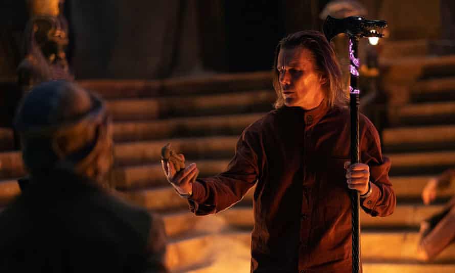 Ethan Hawke as Arthur Harrow, holding a crocodile-headed staff