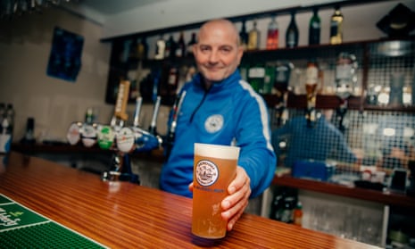 Stuart Slaney, Shoreham FC owner and chairman, pours a pint at the club's bar into their new reusable beer tumblers, which have replaced their disposable plastic glasses to reduce waste