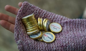 Representatives of Act Alliance hand out chocolate coins, promoting the need for climate finance for adaptation