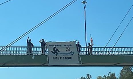 Men displaying offensive neo-Nazi banner