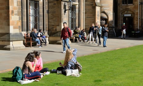 Students sitting in Glasgow University's campus during Freshers Week.