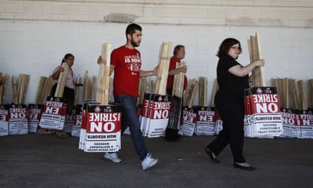 Members of the the Culinary Union carry signs at a union hall on Friday 1 June.