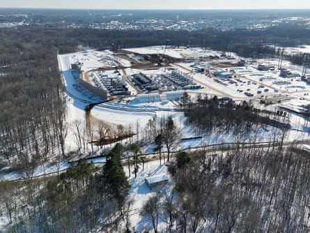 An aerial view of an industrial facility with a house nearby