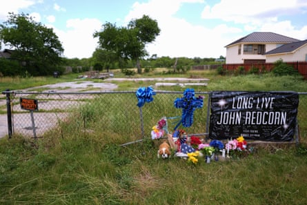 Candles, flowers, and notes are placed at a makeshift memorial in San Antonio