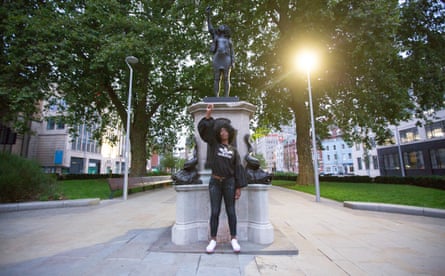 BLM protester Jen Reid stands in front of a statue of her, installed at the site previously occupied by slave trader Edward Colston in Bristol.