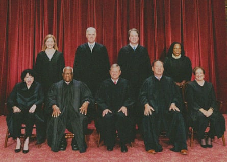nine supreme court justices pose in their robes for a picture