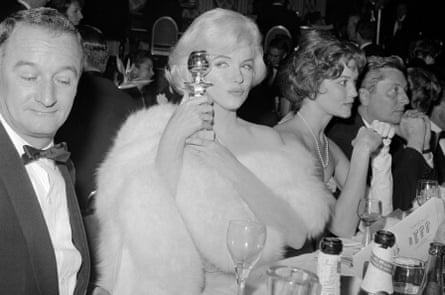 Marilyn Monroe clutches her Golden Globe award with pride after winning Best Actress in a Motion Picture Comedy in the film Some Like It Hot.