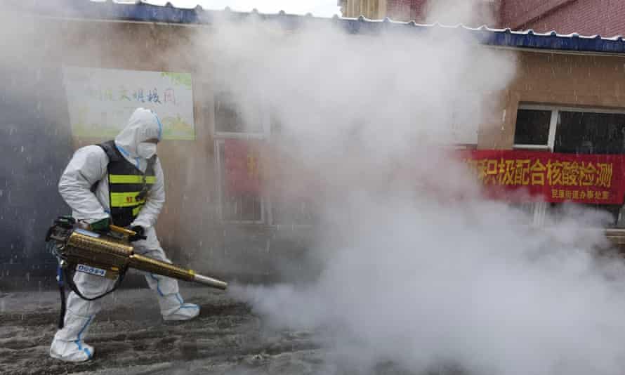 A volunteer disinfects streets in Changchun.