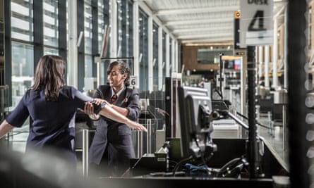 A G4S worker carries out security checks at London’s Heathrow airport.