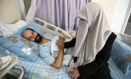 Maher Al-Akhras is visited by his wife, Taghreed, at the Kaplan Medical Center in Rehovot
