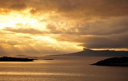 Some islands in a bay with a very yellow sunset