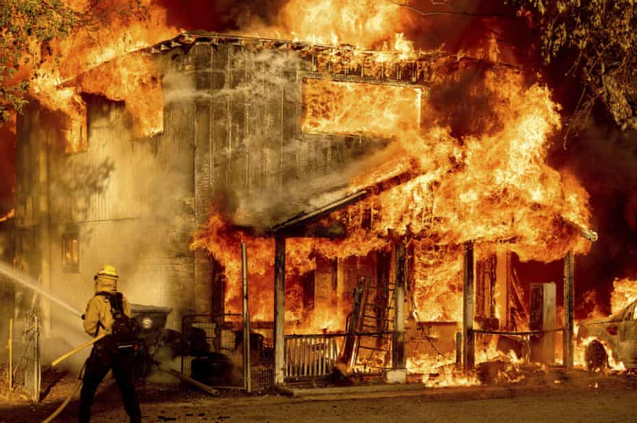 A firefighter sprays water while trying to stop the Sugar fire, part of the Beckwourth complex fire, in Doyle, California in July.