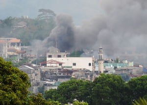 Smoke rises near a public market after military helicopters fired rockets on the positions of Muslim extremists in Marawi,