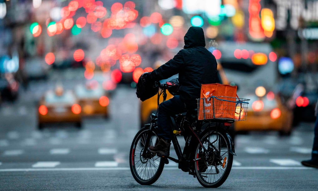 Food delivery workers have become essential in New York after the city closed restaurants and bars to the public on 16 March.