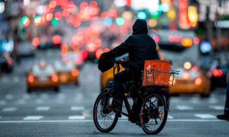 Food delivery workers have become essential in New York after the city closed restaurants and bars to the public on 16 March.