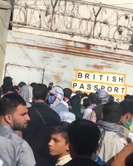 People queue near 'British passport holders' sign