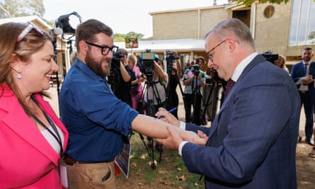 Anthony Albanese in early 2024 pledging to maintain the GST deal by signing a promise on a West Australian journalist’s arm.