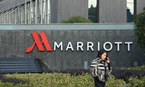 Woman walks past a Marriott hotel in Hangzhou