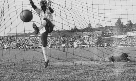 Pelé slams the ball into the net for Santos against Guarani of Paraguay in 1958.