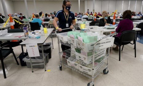 Election workers sort early ballots in October 2020, at the Maricopa county recorder’s office in Phoenix. 