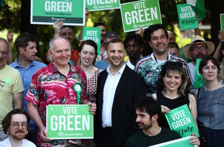 Polanski with smiling supporters with placards