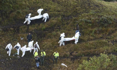 Rescue workers carry the boris of victims of an airplane that crashed in La Union, a mountainous area outside Medellin, Colombia,
