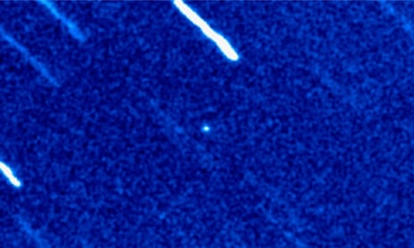 A false-colour image of the object, which appears as a faint point of light in the centre. The streaks are stars, caused by the telescope tracking the object.