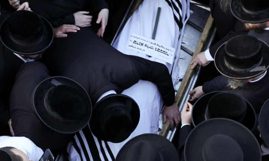 Ultra-Orthodox Jewish men mourn over the body of Shraga Eliyahu Gashtner, who died during Lag B’Omer, at his funeral in Jerusalem on 30 April.