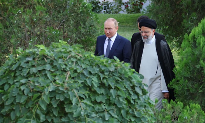 Vladimir Putin (left) walks with Iran’s president Ebrahim Raisi in Tehran on Tuesday.