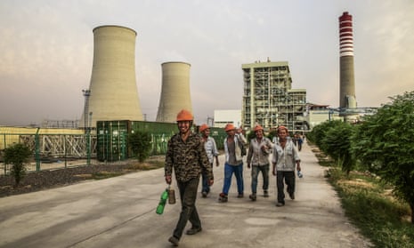 Chinese workers walk along a path at the Sahiwal coal power plant  in Sahiwal, Pakistan.