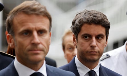 Gabriel Attal watching Emmanuel Macron talking to the press.