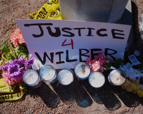 a sign saying 'justice 4 Wilber' is placed next to candles and flowers