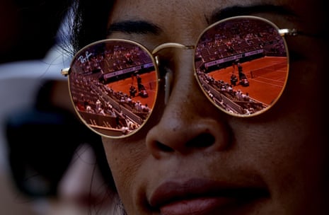 Court Philippe Chatrier is reflected in the sunglasses of a spectator