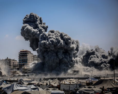 Smoke rises from the Harmony Tower, right after being bombed by Israeli forces in western Gaza City.